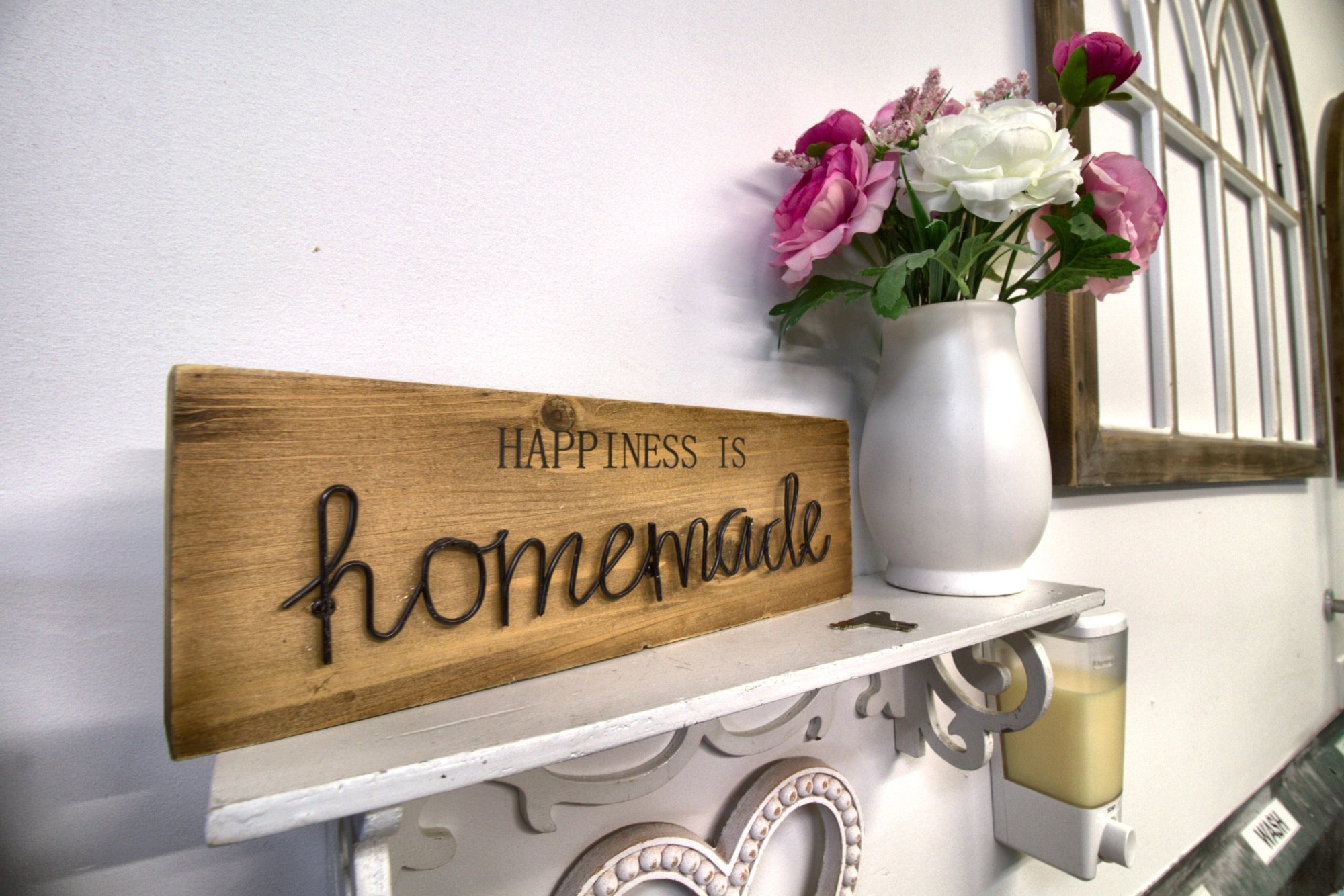 "Happiness is homemade" sign with fresh flowers in the bakery
