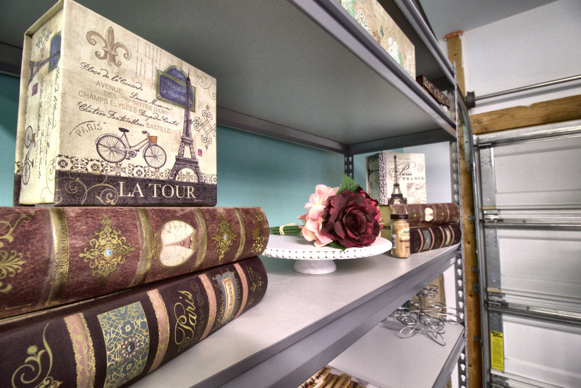 Paris-themed decor with a fresh rose on the bakery's shelving
